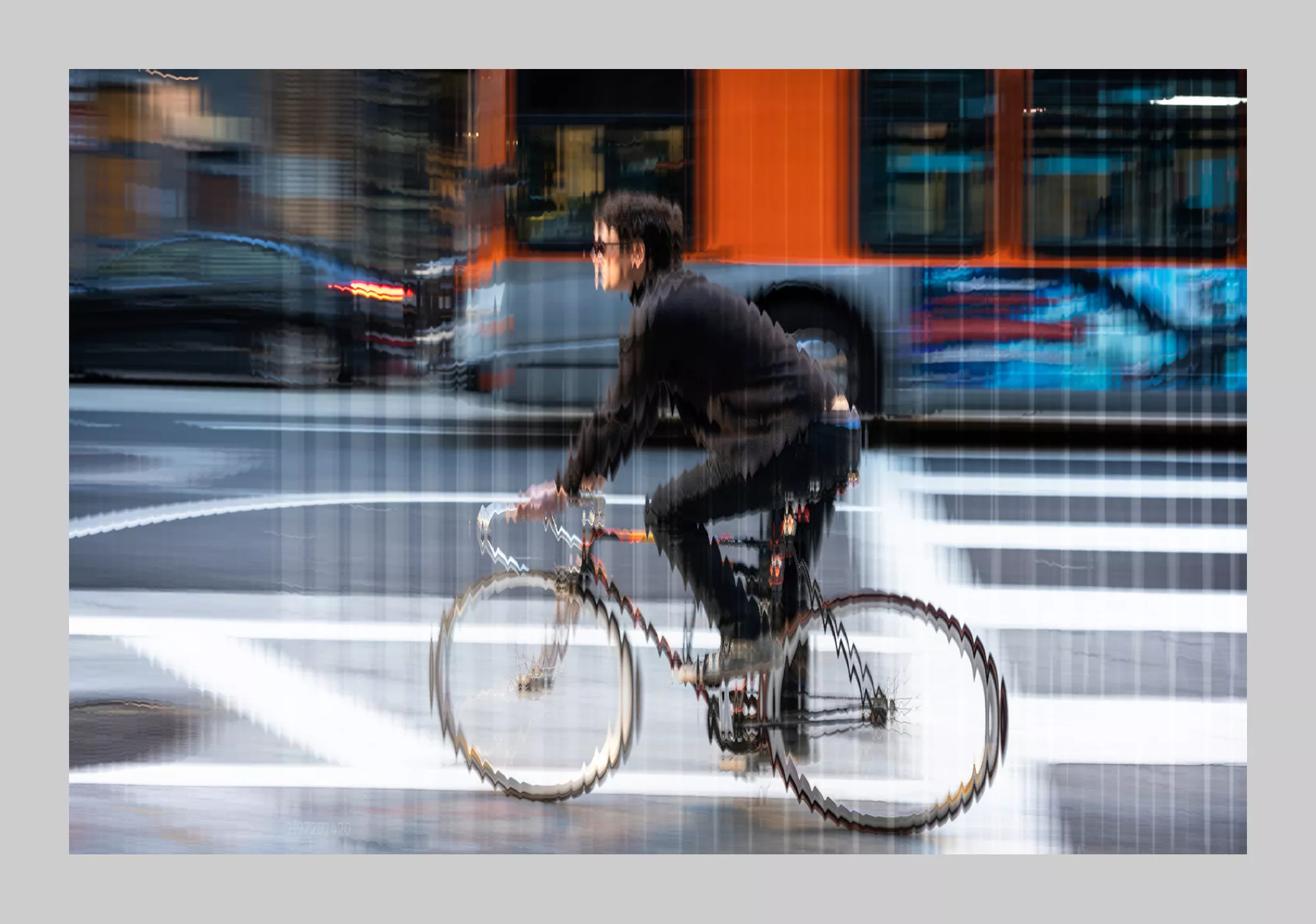 Accent photo of man riding a bike in the city.