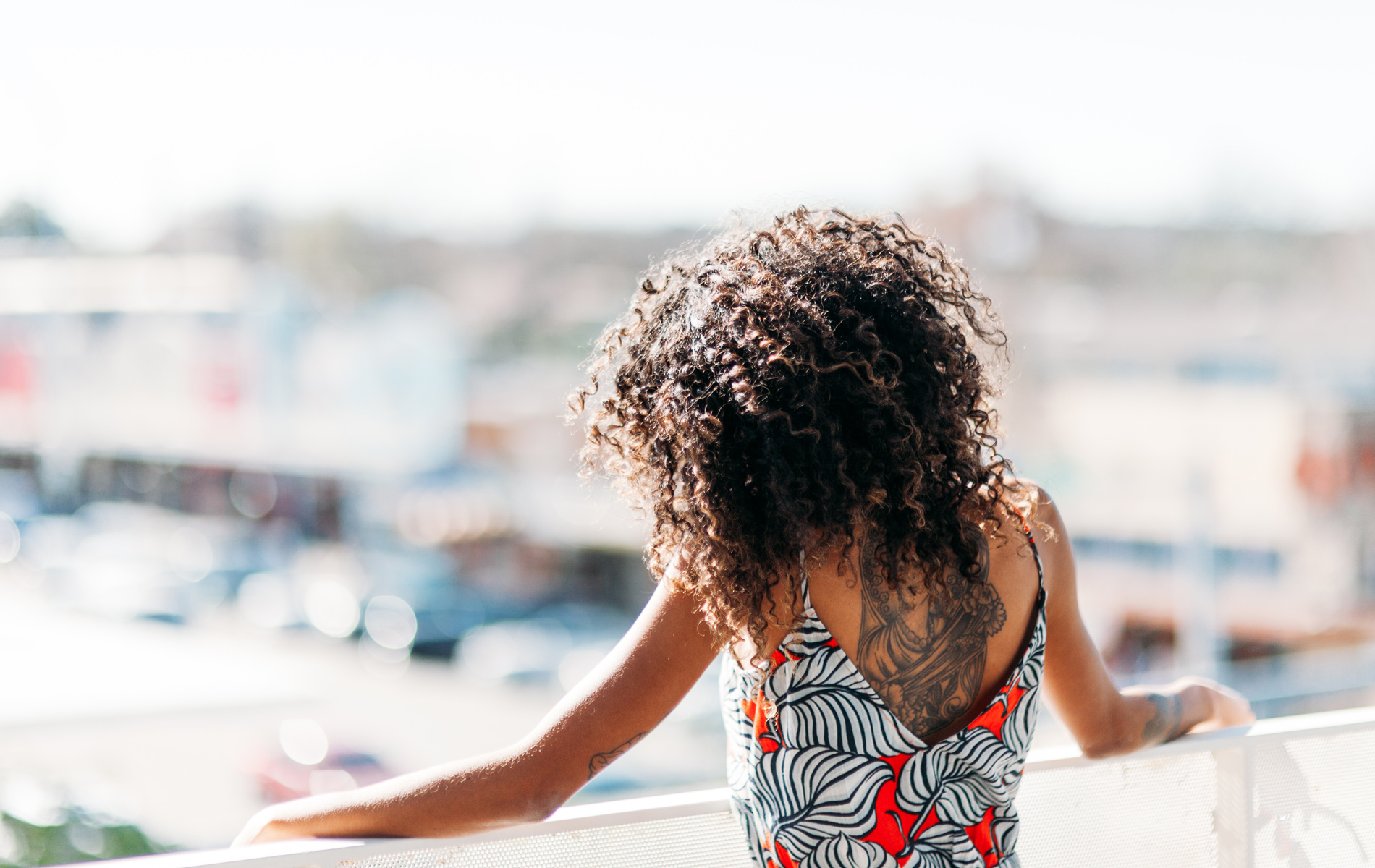 Stylish woman on outdoor deck looking out to the view.