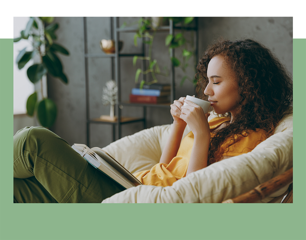 Young woman reading a book drinking coffee