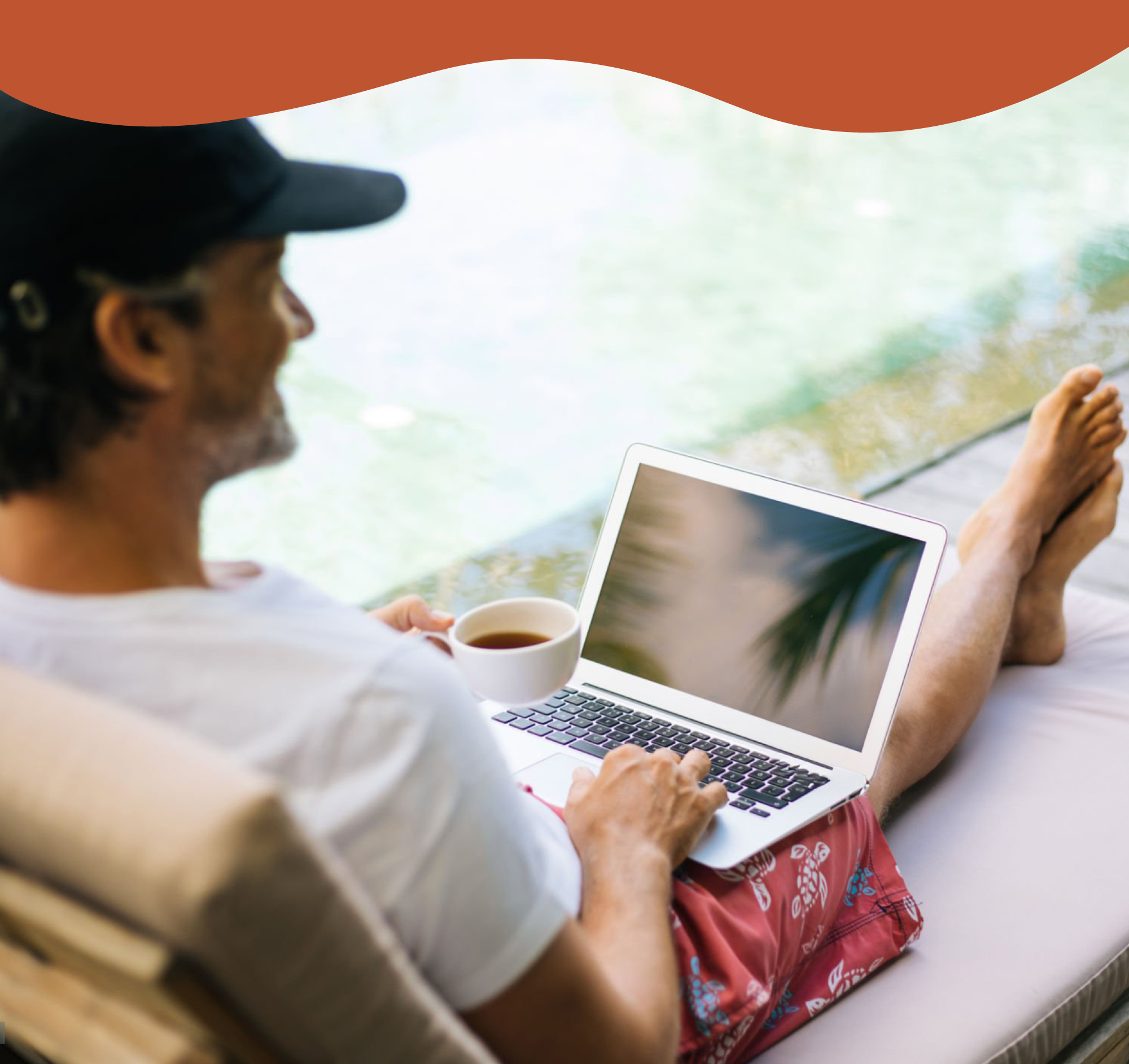 accent photo of a man lounging outdoors with a laptop computer