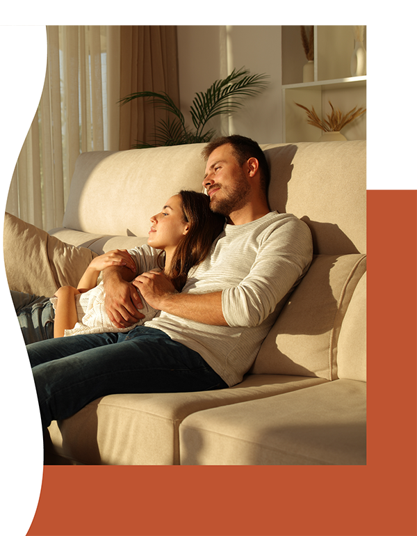 accent photo of a young couple relaxing on the sofa.